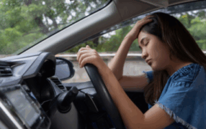 Drowsy driver at the wheel of a car. ADAS system will help.