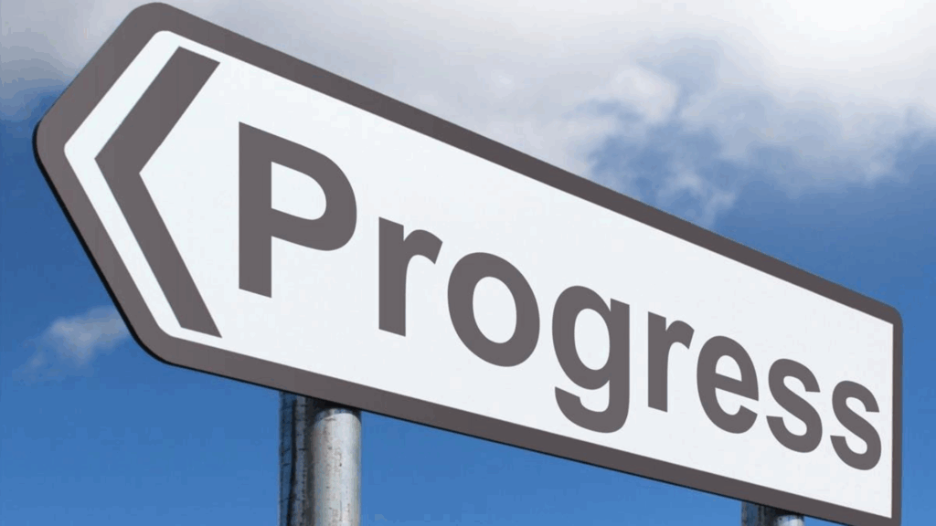 A road sign with the words progress.
