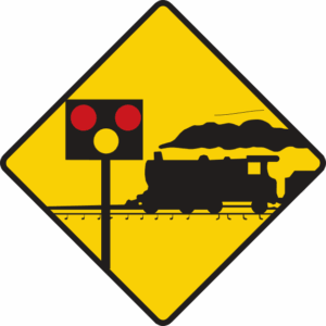 Level crossing ahead protected by lights and barriers.